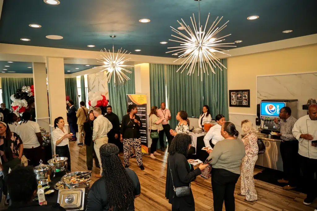 Guests enjoying a catered event in the upstairs event space at This Is It! Camp Creek in East Point, GA